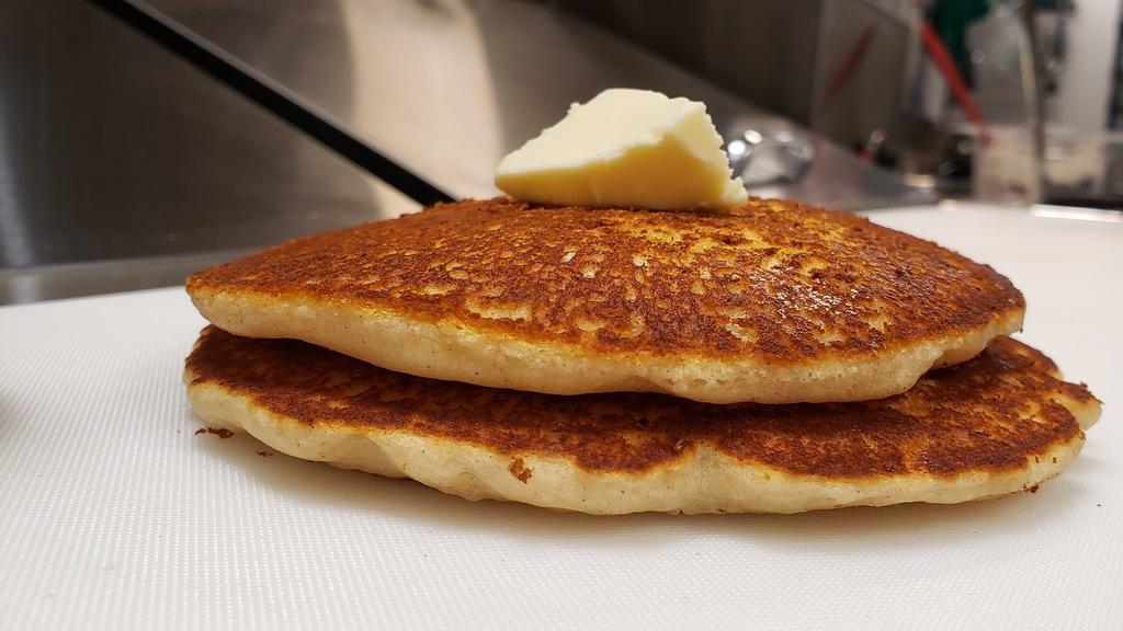 Pancakes · 2 pancakes with a side of butter and syrup