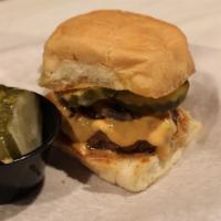 Slider · Two ounces patty, grilled onion, pickle and sauce on a grilled bun and cheese.