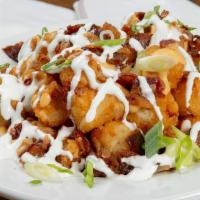 Loaded Tots · Bacon, cheese, green onions and sour cream.