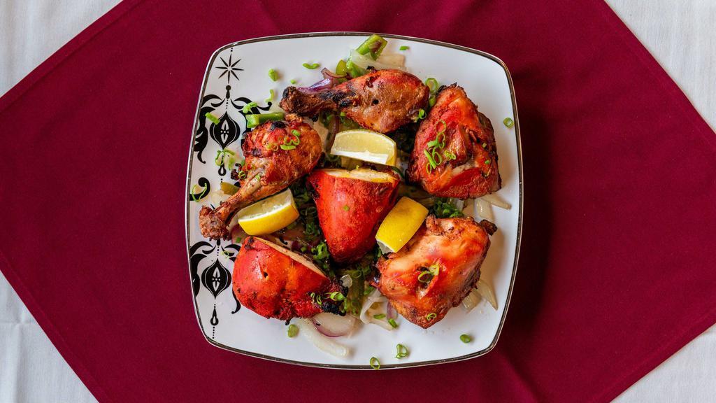Tandoori Chicken · Chicken marinated in yogurt with spices and grilled in tandoor oven.