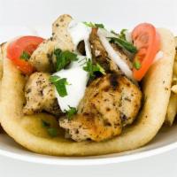 Chicken Souvlaki Pita · Pieces of chicken marinated in olive oil, lemon and greek spices on a pita.  Served with tza...