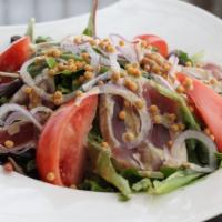 Seared Ahi Salad · Seared ahi tuna with mixed greens, red onion, cherry tomato, shredded daikon, toasted rice c...