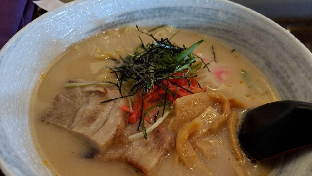 Tonkatsu Ramen · Includes pork belly, bamboo shoots, fish cake, green onions, bean sprouts, pickled red ginger, and poached egg.