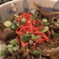 Gyudon · Thinly sliced chuck beef, braised in a sweet soy sauce with carmelized onions. Garnished wit...