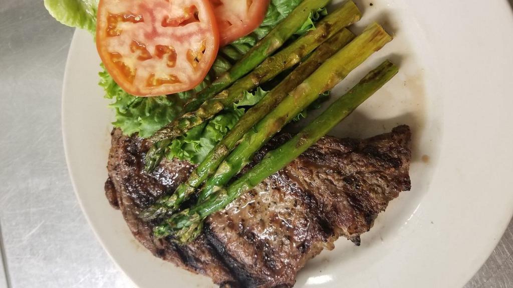 Classic Rib-Eye · 12 oz hand trimmed rib-eye steak char-grilled to perfection with sea salt and black pepper. Served with choice of baked potato or creamy mash potatoes, roasted asparagus, home made au jus steak sauce and french bread.