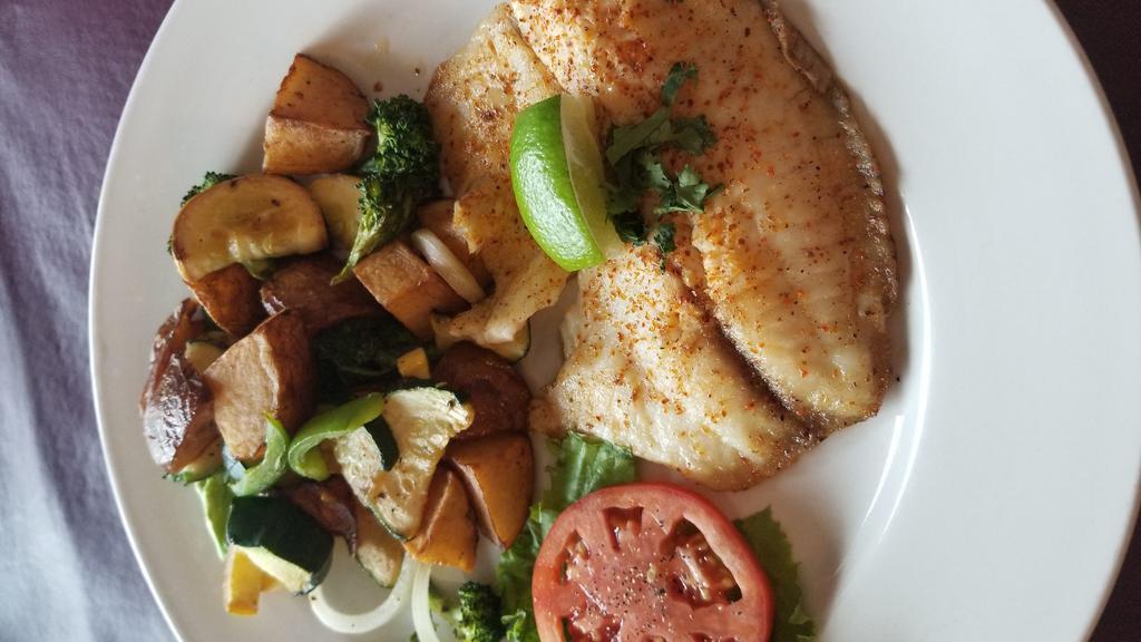 Baked Tilapia · Tilapia with lemon butter. Served roasted bell peppers, onions, potatoes wedges, zucchini, and bread.
