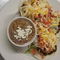 Ground Beef Tacos · Three hard or soft shell ground beef tacos with lettuce, tomatoes, cheese and red chile sauc...