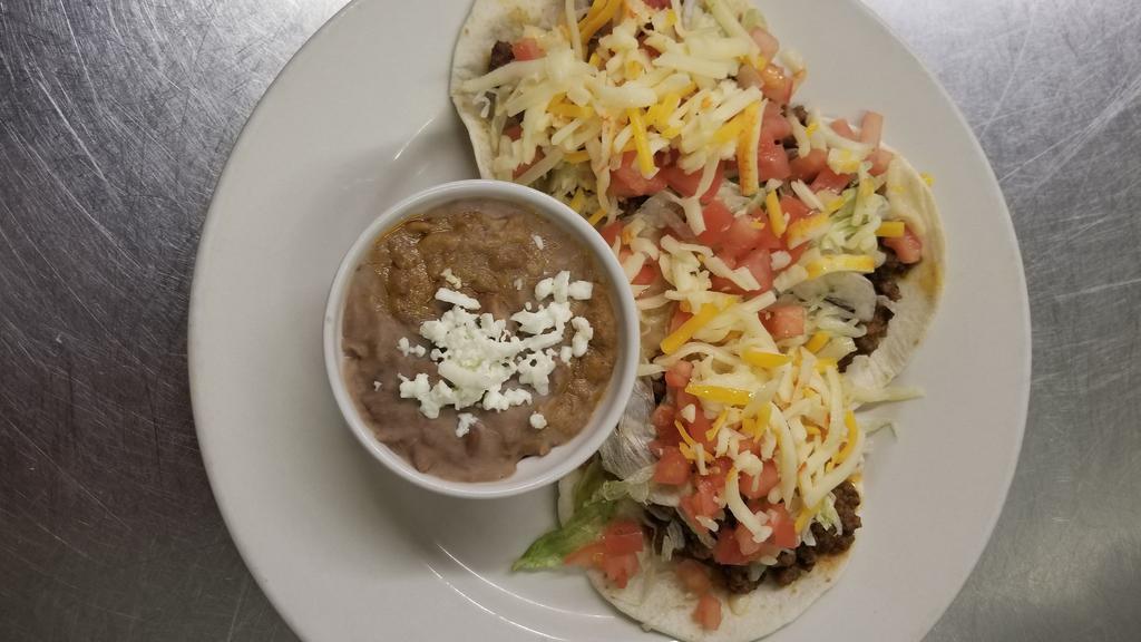 Ground Beef Tacos · Three hard or soft shell ground beef tacos with lettuce, tomatoes, cheese and red chile sauce and spanish rice.