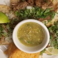 Carnitas Tacos · Three pork tacos topped with onions, cilantro, salsa verde. Served with black beans and span...