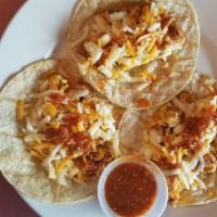 Scrambled Eggs & Chorizo Tacos · Three scramble eggs and chorizo tacos with shredded cheese and red sauce and spanish rice.