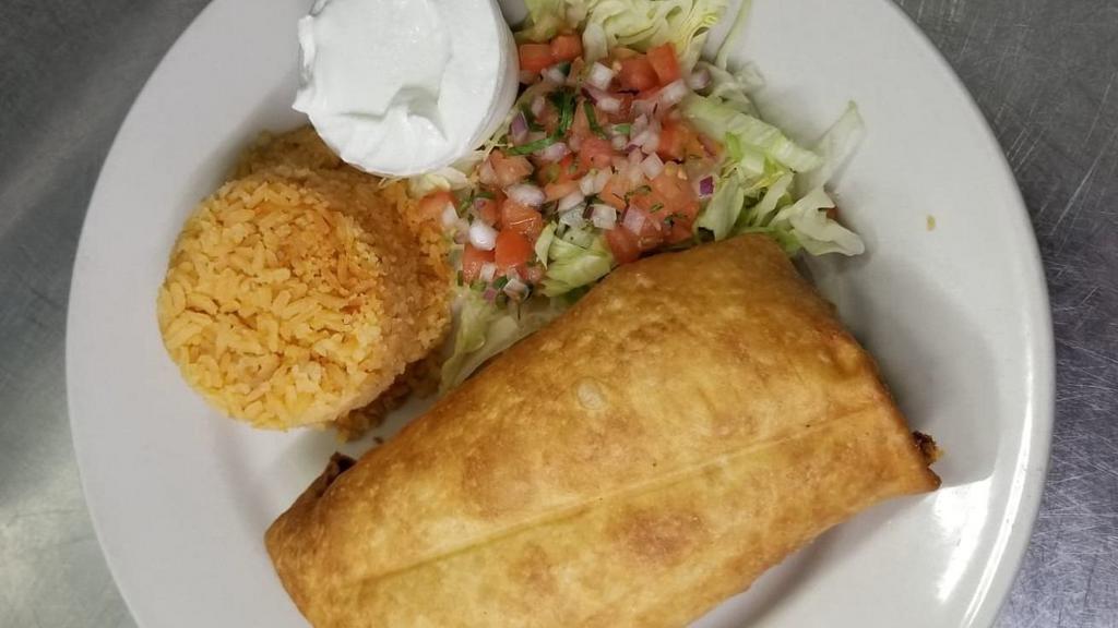 Chimichanga Grande · Crispy fried flour tortilla filled with chicken or ground beef, cheese. Served lettuce, pico de gallo, spanish rice and sour cream.