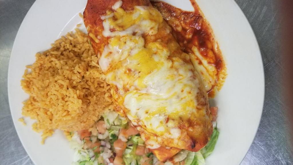 Burrito Macho Grande · Flour tortilla filled with black bean cream, cheese and choice of ground beef, chicken, steak or pork. Served with lettuce, pico de gallo and spanish rice. Burrito macho topped with melted cheese and red sauce.