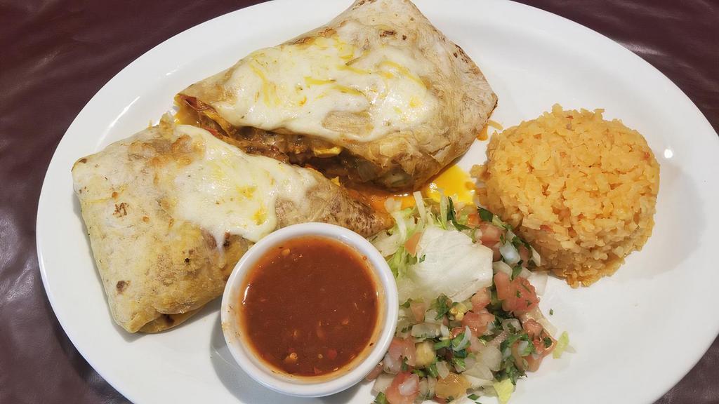 Breakfast Burrito Grande · Flour tortilla filled with scrambled eggs, chorizo, cheese, smashed potatoes, roasted onions and bell peppers and red sauce.