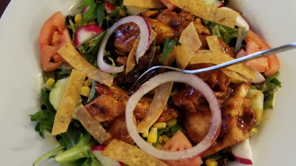 Southwest Chipotle Salad · Grilled chicken, spring mix, corn, black beans, tomatoes, radishes, cucumbers, tortilla strips and chipotle dressing.