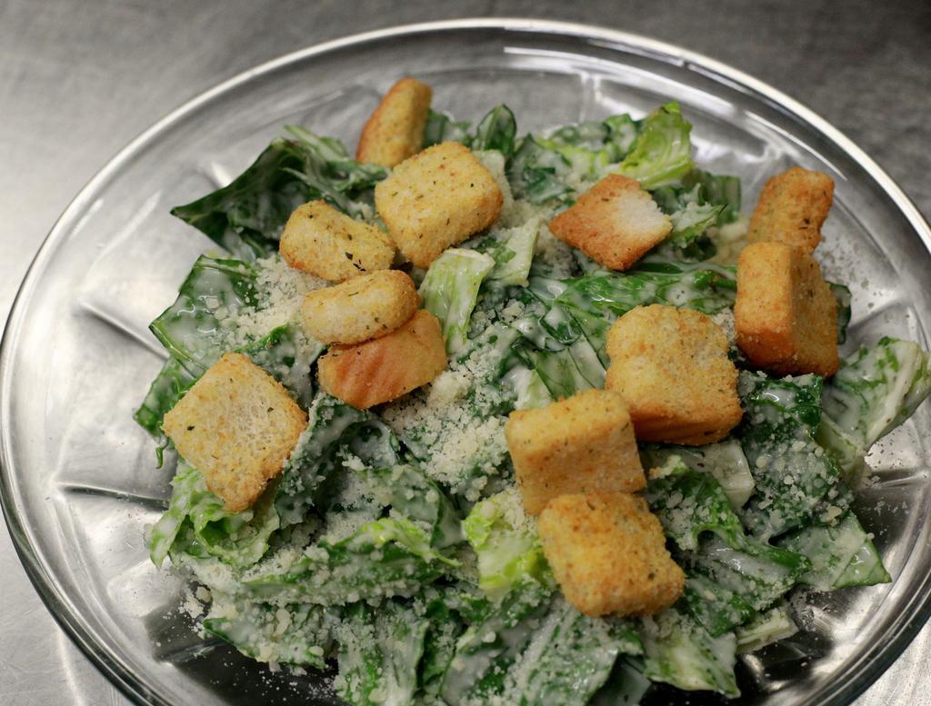 Caesar Salad · Romaine lettuce, croutons, and freshly grated parmesan cheese. Tossed with caesar dressing.