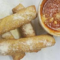 Mozzarella Logs · Fresh mozzarella cheese sticks deep fried, dusted with parmesan cheese and served with marin...