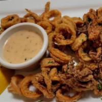 Fried Calamari · Tender calamari, lightly breaded and fried. Served with our special sauce and lemon wedges.