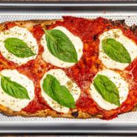 Pinsa Romana Margherita · Artisan hand-crafted roman-style pizza with tomato sauce, fresh Mozzarella, and fresh basil.