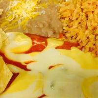 Cancun Enchiladas · 3 Enchiladas, Choice of Chicken, Beef, or Cheese and Onion, Enchilada Sauce, Nacho Cheese, M...