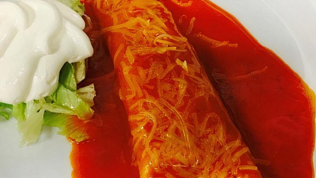 Enchilada · Choice of Chicken, Beef, or Cheese and Onions, Enchilada Sauce, Shredded Cheese, and Sour Cream