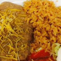 Kid'S Cheese Enchilada · Cheese Enchilada, Enchilada Sauce, Shredded Cheese, Sour Cream, Rice, and Beans