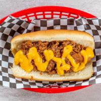Chili Cheese Dog · Left bank dog with melted cheddar cheese and homemade chili on top.