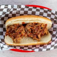 Kc Dog · Left bank dog topped with BBQ pulled pork and homemade sauce.