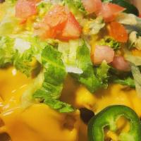 Holy Nachos · Tortilla chips topped with seasoned ground refried beans, melted cheddar, lettuce, tomato fr...
