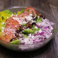 Greek Salad · Romaine lettuce, Feta, Tomatoes, red onions, kalamata olives, Banana Pepper Rings, Italian D...