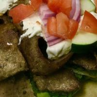 Gyro Sandwich · Pita bread gyro meat, grilled onions, cucumber sauce, tomatoes, lettuce.