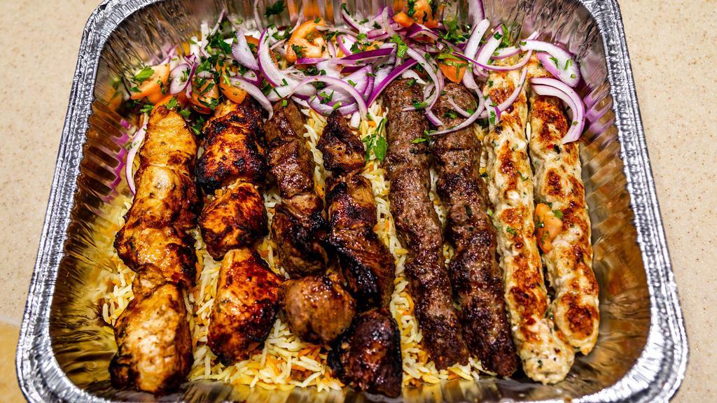 Rayan Mixed Grill · Three skewers of our most popular natural wood mesquite-grilled kababs (shish kabab, kuftah kabab, chicken tawook kabab), a shawarma grilled tomatoes & onions, along with your choice of humus or house salad. Served with rice.