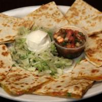 Quesadillas · Grilled flour tortillas filled with cheddar and Monterey Jack cheese, tomatoes and green oni...