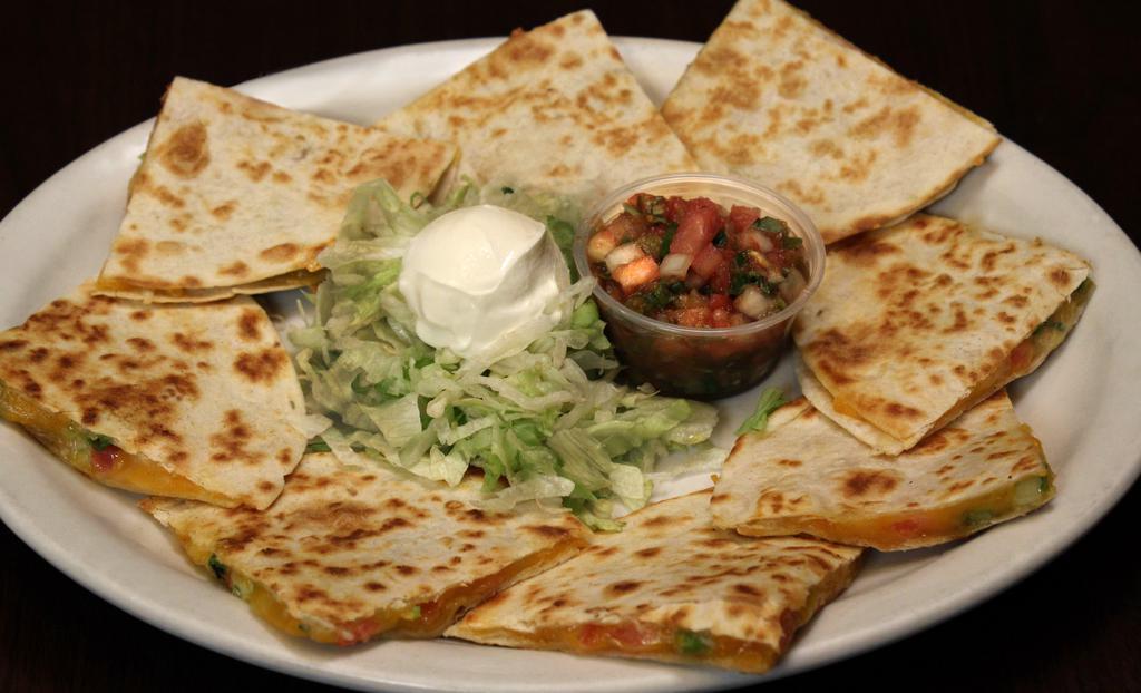 Quesadillas · Grilled flour tortillas filled with cheddar and Monterey Jack cheese, tomatoes and green onions. Add chicken or steak for an additional charge.