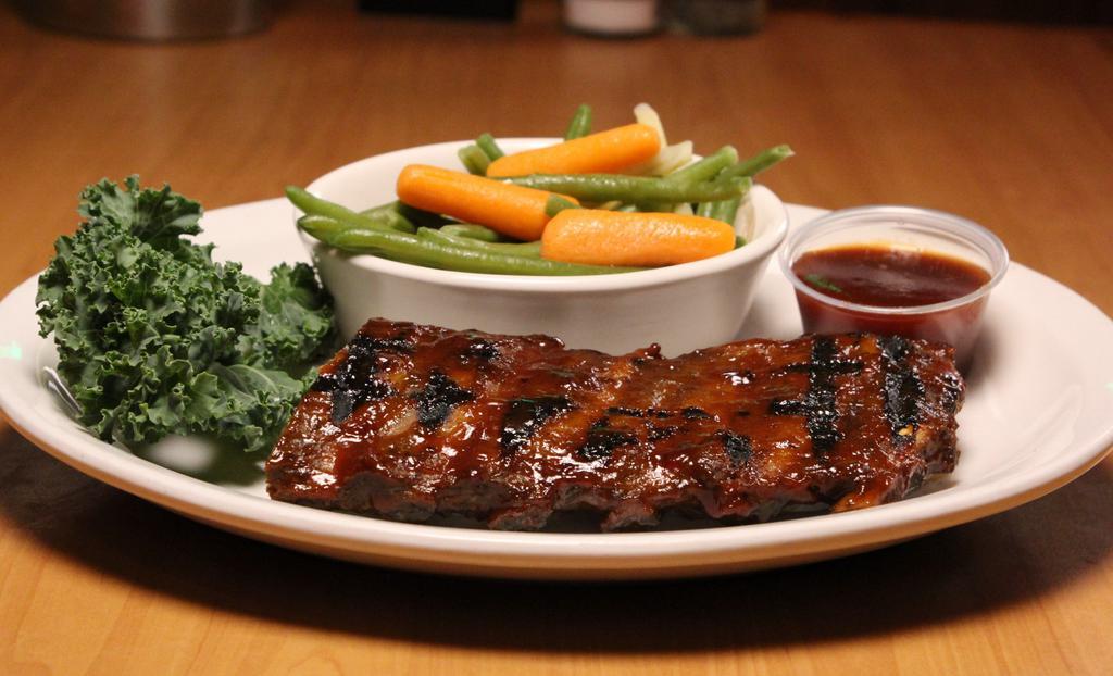 Fall-Off-The-Bone Baby Back Bbq Ribs · Baby back ribs slow roasted and caramelized on the grill with our signature BBQ sauce.