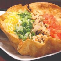 Taco Salad · A crisp tortilla shell filled with shredded lettuce, diced tomatoes, shredded cheese, green ...