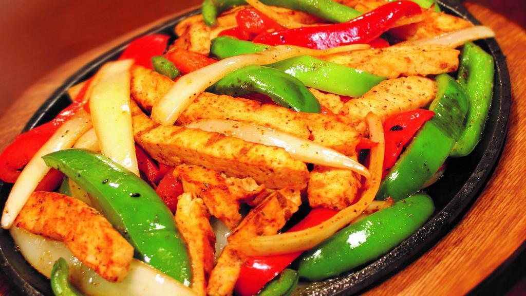 Steak Fajitas · Marinated strips of steak with grilled peppers and onions.