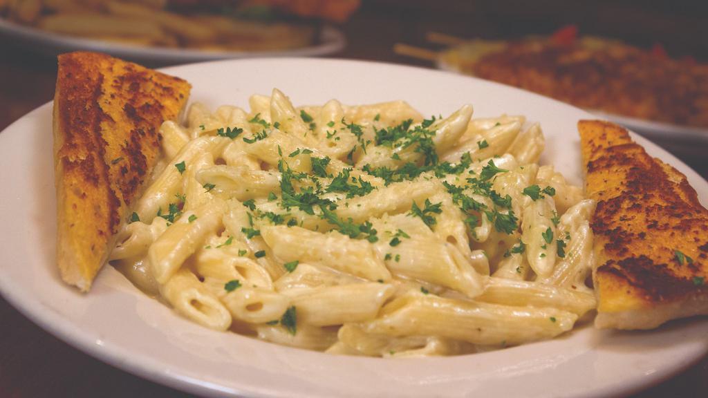 Pasta Alfredo · Al dente penne pasta prepared with our creamy Parmesan sauce and served with garlic bread.