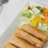 Vegetable Spring Rolls · Crispy mixed vegetable spring rolls. Served with mild (tomato-based sauce) and hot sauces (r...