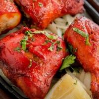 Tandoori Chicken · Marinated in yogurt with ginger, garlic, herbs, and grilled in a clay oven to perfection.