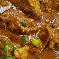 Goat Curry · Goat meat with bone pieces simmered in onion and tomato sauce with a blend of aromatic spice...