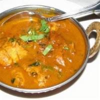 Fish Curry · Fish cooked in curry sauce. Served with side basmati rice.
