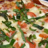 Caprese · Red sauce, fresh Roma tomatoes, fresh mozzarella, fresh basil with mozzarella, provolone and...