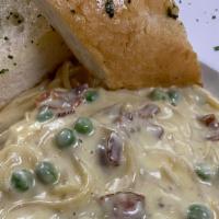 Spaghetti Alla Carbonara · Sautéed bacon and peas with spaghetti tossed in our creamy cheese sauce.