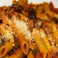 Penne Alla Putanesca · Penne pasta sautéed with olive oil, garlic, capers and kalamata olives in a wine tomato & or...