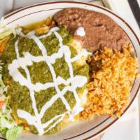 Enchiladas Suizas · 3 chicken enchiladas with verde sauce, melted cheese, crema and rice and beans.