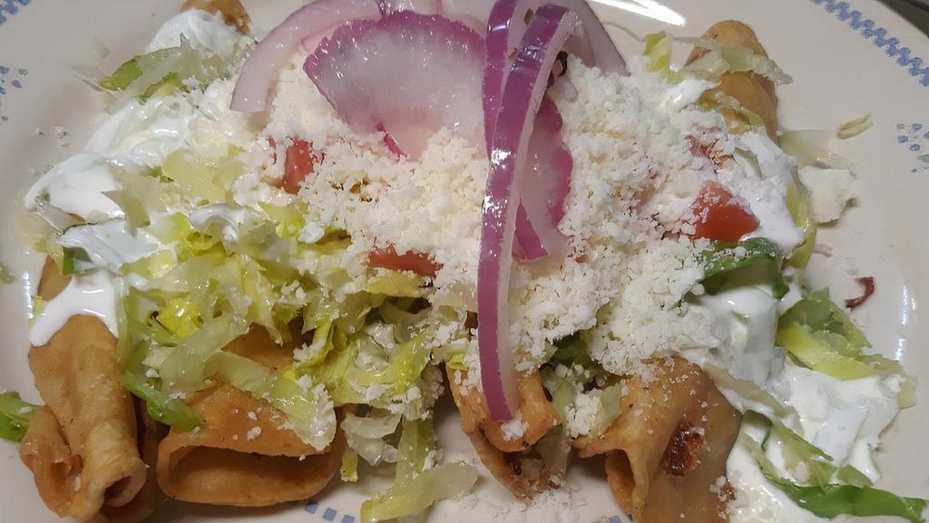 Flautas · Four handmade corn tortillas filled with cheese or chicken topped with lettuce, tomatoes, crema and shredded cheese.