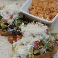 Sopes · Choice of chicken, carnitas, pastor or steak topped with lettuce, queso cotija and sour crea...