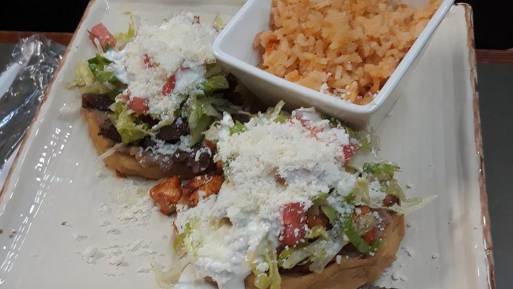 Sopes · Choice of chicken, carnitas, pastor or steak topped with lettuce, queso cotija and sour cream on thick homemade tortillas.