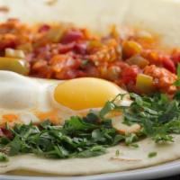 Huevos A La Mexicana / Mexican Style Eggs · Dos huevos revueltos con pimiento verde picante, cebolla y tomate servidos con frijoles refr...