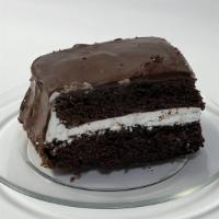 Ding Dong Cake · Rich chocolate cake layered with fluffy white filling and covered in chocolate ganache.